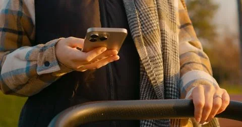 Female using smartphone while rocking stroller Stock Photos