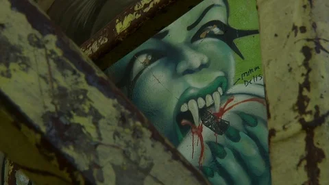Female Vampire, Biting Spray Paint Can, Graffiti Mural - Close Up - Sacrament Stock Footage 92055077