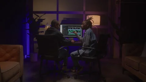 Female Video Editors Collaborating in a Studio Late at Night Video stock 270322997