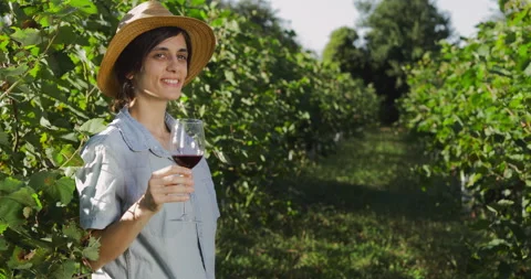 Female in vineyard drinking wine Stock Footage 138906521