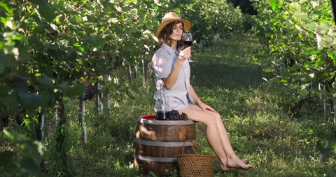 Female in vineyard drinking wine Stock Footage 139097452