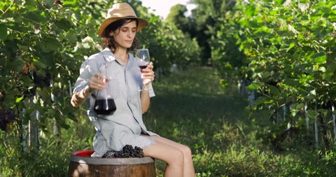 Female in vineyard drinking wine Stock Footage 139115495