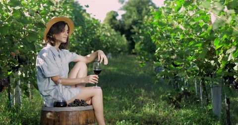 Female in vineyard drinking wine Stock Footage 139119404