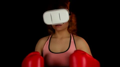 Female in virtual reality headset invite to play in boxing video game Stock Footage 62344022