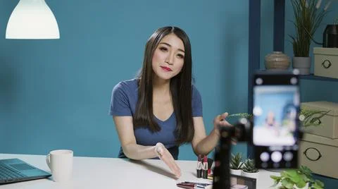 Female vlogger recording beauty tutorial for social media 写真素材