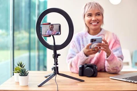 Female Vlogger Recording Camera Tutorial Video At Home With Mobile Phone 写真素材