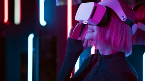 Female in VR glasses interacting with network while having virtual reality. Stock Footage 261960187