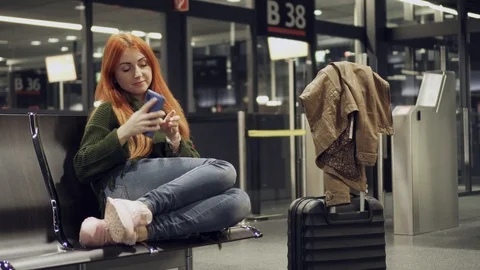 Female is waiting for delayed flight at night airport. Stock Footage 105078784