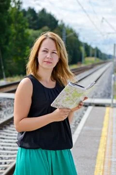 Female waiting train on the platform Stock Photos