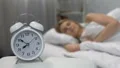 Female waking up easily to ringing alarm clock in morning, healthy lifestyle HD Footage