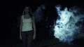 The female walking in a dark street against a man silhouette in a smoke cloud 4k or 4k+ Resolution
