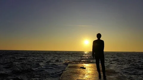 Female walking by the ocean with waves on sunset Stock-Footage 119548686