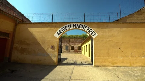 Female walking through the gate of the concentration camp Theresienstadt  Video stock 92620250
