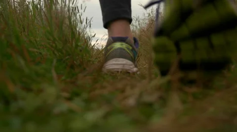 Female Walking through Grass Pathway to Ocean. Stock Footage 65315202