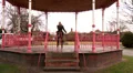 Female walking through park on phone HD Footage