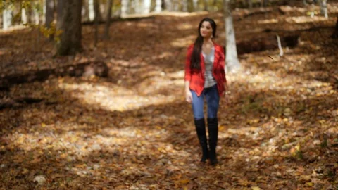 Female walking towards the camera in the forest. Fall colors Video stock 103435049