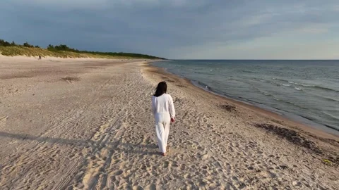 Female walks on the beach Stock Footage 241449129