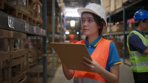 Female warehouse staff checking inventory Stock Footage 206356895