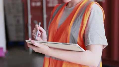 Female warehouse staff using digital tablet checking import export logistic Stock Footage 164642095