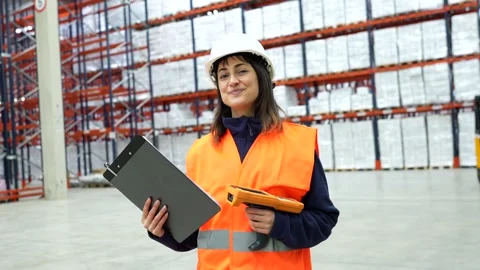 Female warehouse worker scanning and checking inventory Stock Footage 305647576