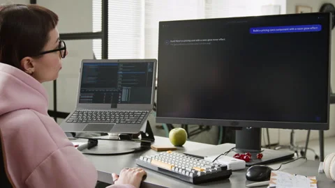 Female Web Developer Watching Vibe Coding Assistant Writing Script Stock Footage 335940721
