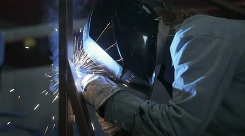 Female Welder Assembles Steel frame in Industrial Metal Shop Stock Footage
