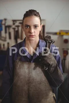 Female Welder Holding Wrench Tool
