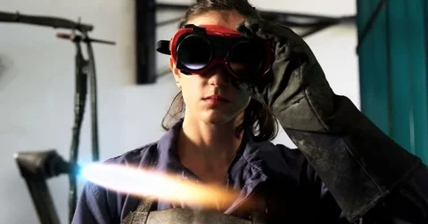 Female welder welding a metal Stock Footage