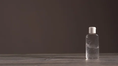 Female white hands take a transparent plastic bottle with a liquid gel  Stock Footage 130852277