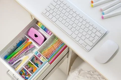 Female white workplace. A method for storing stationery neatly. Stylish colored Stock Photos