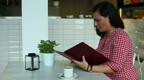 Female woman reading menu in cafe Stock Footage 67998853