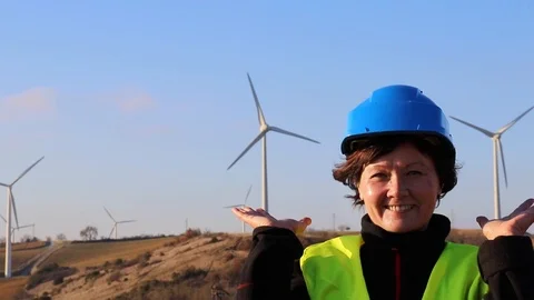 A female worker against a background of wind turbines. Stock Footage 87913025