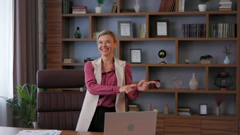 Female worker celebrating the end of working day at office. Happy businesswoman Stock Footage 218977036