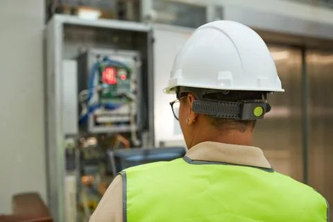 Female Worker Checking Electric Systems Back View Stock Photos