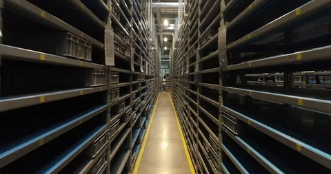 The female worker is checking the inventory in the warehouse of car factory. The Stock Footage 87389910