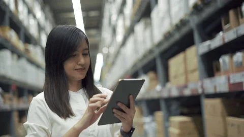 Female worker checking products with tablet in warehouse. Stock Footage 151281545