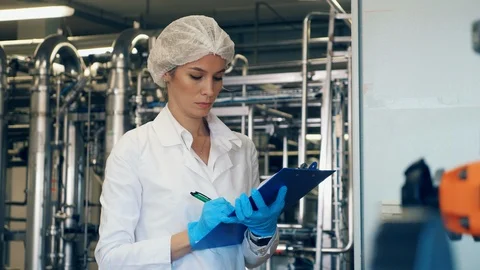 Female worker checks factory equipment, industrial machines. Video stock 122129341