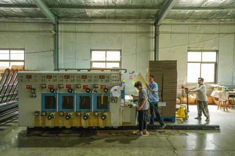 Female Worker Cleaning Rollers in the Gap of Printing Machine Equipment Stock Photos