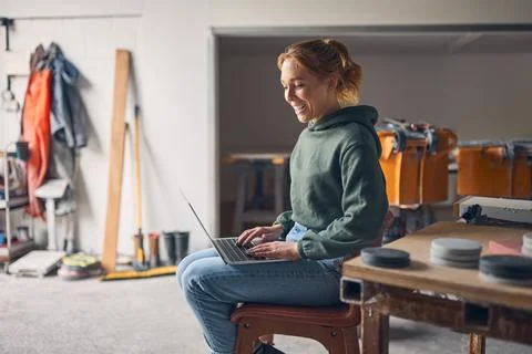 Female Worker In Concrete Workshop Using Laptop Computer Foto stock
