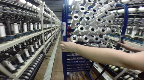 A Female Worker Empties Spools of Processed Cotton Yarn in Modern Textile Mil Stock Footage 63459177