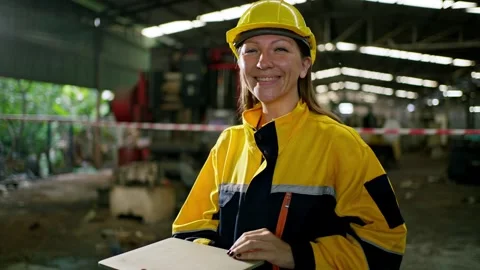 Female worker in hard hat and safety jacket in factory warehouse industry e.. Stock Footage 332503828