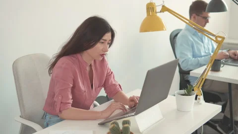 Female worker looking at screen in home office. Happy millennial asian ethnicity Video stock 131145977