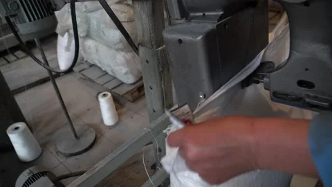 A female worker packs sugar using machine on the conveyor belt of sugar beet pla Stock Footage 166366926
