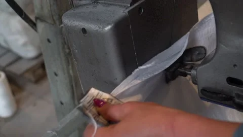 A female worker packs sugar using machine on the conveyor belt of sugar beet pla Stock Footage 166366932