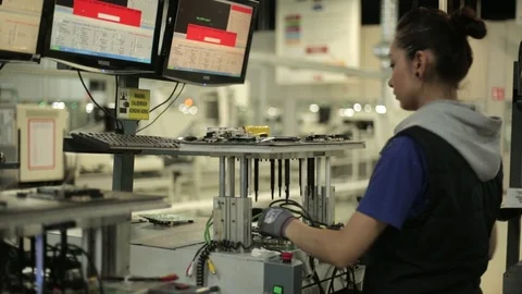 Female worker producing and testing electronics on modern factory Stock Footage 105180465