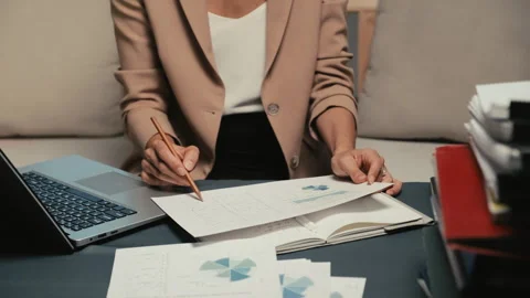 Female Worker Revising Financial Document at Office Video stock 248826346