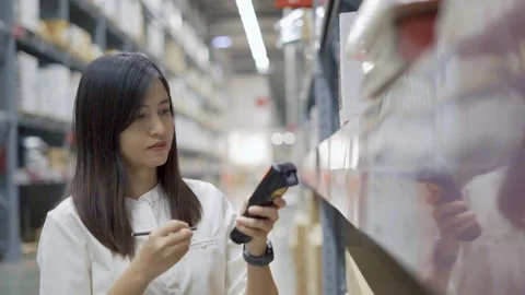 Female worker scanning products with barcode scanner in warehouse. Stock Footage 233284086