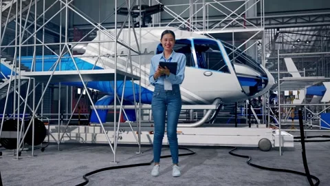 Female Worker Use A Tablet And Smiling To Camera and Inspecting Helicopter Stock Footage 312127698