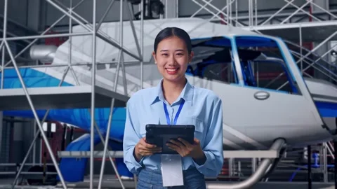 Female Worker Use Tablet And Smiling To Camera and Inspecting Helicopter Stock Footage 312127759