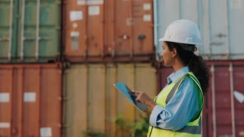 Female Worker Walking Outside With Tablet At Cargo Containers Wearing Safety Stock Footage 316402879